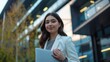 © Fotograf - A woman sits with a laptop, ready to work or study