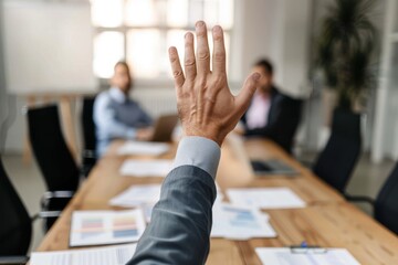 Wall Mural - Unrecognizable businessman asking a question on a meeting in the office. Unrecognizable person raising his hand to ask a question on a business meeting in the office.