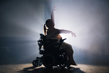 Graceful and elegant movements of a woman with a disability during a solo dance choreography performance on a wheelchair