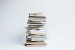 © Zivorad - A neatly stacked pile of various books on a plain white background, representing knowledge, education, and endless stories, ideal for a minimalist artistic depiction.