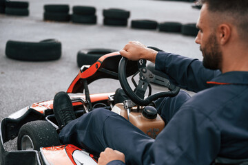 Wall Mural - Parked, driving out. Man is outdoors, kart racing conception