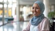 © SH Design - A woman in a wheelchair with a blue scarf and a blue head scarf