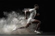 © Hugo - Cinematic moody light in studio against black of male high speed Athlete sprinter running through dust and smoke.