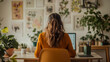 © HillTract - A young woman sits at a desk in her home office, facing away from a laptop on the table.