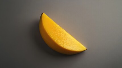 Wall Mural - A Single Slice of Ripe Mango on a Gray Surface