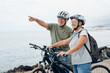 © Daniel - Two happy old mature people enjoying and riding bikes together to be fit and healthy outdoors. Active seniors having fun training in nature. Portrait of one old woman smiling in a bike trip with