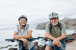© Daniel - Portrait of couple of old and happy in love seniors looking at the camera smiling and having fun with their bikes in the nature outdoors together feeling good and healthy.