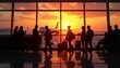 © abu - Silhouetted passengers wait by an airport window as a sunset-lit airliner prepares for departure.