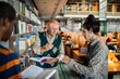 © Marko Geber - Professor helping students in the college library
