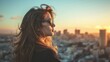 © Ruslan Gilmanshin - A woman wearing stylish sunglasses gazes out at a city during sunset