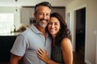 © NikoG - Portrait of a smiling middle aged Hispanic couple in new home