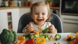 © pkproject - Smiling Toddler Enjoying Pureed Vegetable Meal in High Chair
