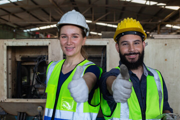 Supervisor engineer and operational level employees wear white helmet thumbs up in uniform standing at machine lathe metal heavy industrial.