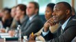 © Cambo27 - Adults attending a business management seminar, taking notes and listening to the instructor in a conference room