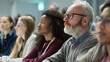 © Cambo27 - Adult students attending a lecture in a modern classroom, listening intently to the instructor