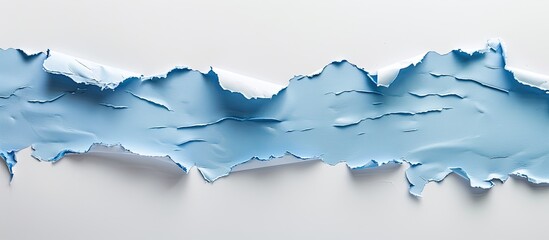 Wall Mural - Blue torn paper on a white paper background. Copy space image. Place for adding text and design