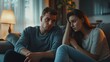 © Naknakhone - Sad man asking sorry to upset woman both sitting on the sofa at home. Discussion between man and woman about jealousy and relationship problems. copy space for text.