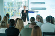 © Anton Gvozdikov - Business conference with audience listening to a speaker presenting. Professional development and networking opportunities showcased.