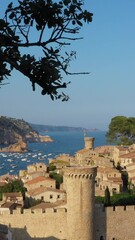 Wall Mural - Tossa de Mar Catalonia Spain coastal Costa Brava. Summer vacation panorama. fortified medieval town with beautiful nature sea and beach. Popular touristic destination. Vertical aerial video footage