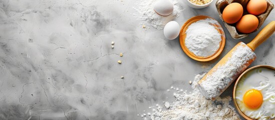 Poster - Top view of baking and cooking ingredients Flour and eggs with a rolling pin on a grey background Bakery background frame Copyspace available Flat lay