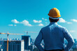 © Weerapat - A construction worker in a hard hat gazes over a city skyline, embodying focus and determination in the building industry.