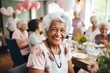 © Baba Images - Portrait of smiling diverse seniors celebrating birthday in nursing home