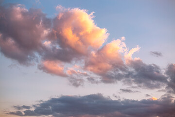 Wall Mural - unusual vivid clouds illuminated by the beams of the sun.
