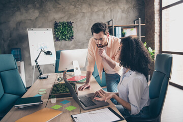 Photo of smart coworkers female man working together brainstorming comfortable modern office interior indoors workspace