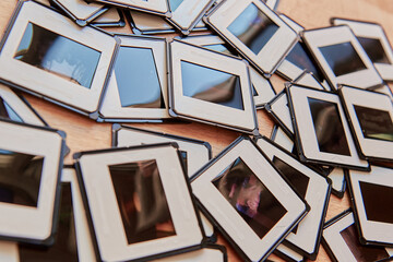 Scattered vintage photo slides on a wooden surface background