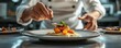 © ChomStyle - A chef plating a dish in a fine dining restaurant