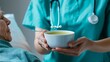 © prime stock - Nurse offers soup to elderly in bed, Warm gentle lighting, Caring nurse-patient interaction, Elderly care, Nutritional support