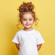 © carolina - design mockup toddler girl wearing plain blank white tshirt on a yellow background, studio portrait