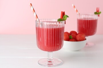 Sticker - Tasty watermelon drink in glasses and fresh fruit on white wooden table, closeup