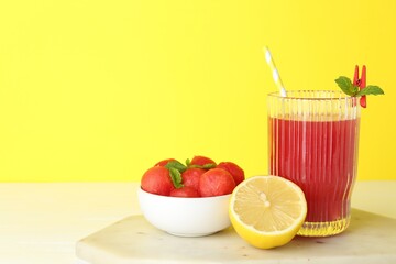 Wall Mural - Tasty watermelon drink in glass and fresh fruits on white table. Space for text