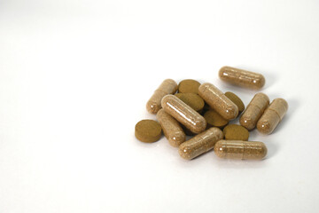 close up of  herbal medicine capsules on the white background isolated