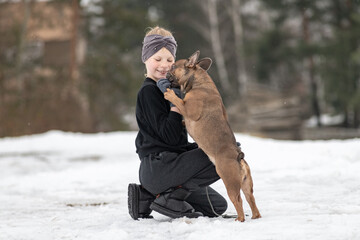 Portrait of a beautiful ten year old girl with a dog.