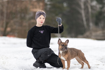 Wall Mural - Portrait of a beautiful ten year old girl with a dog.