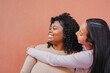 © Sabrina - Happy latin women having tender moment - Multiracial female friends - Neutral background and copy space