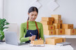 © David - Small business entrepreneur SME freelance asian woman working at home, check online, marketing, packaging, delivery, sell to customers, sme e-commerce concept.