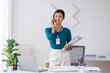 © David - Asian woman entrepreneur busy with her work in the office. Young Asian woman work on desk laptop phone while planning sales, research or financial strategy in company