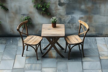 Set of wooden table and two chairs on outdoor stone floor