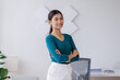 © David - Portrait of young Asain business woman standing with confidence expression arms crossed and looking at the camera in the office.