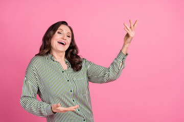 Wall Mural - Portrait of pretty aged lady enjoy dancing wear striped shirt isolated on pink color background