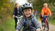 © liliyabatyrova - A young boy is riding a bike with a helmet on and smiling