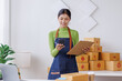 © David - Startup SME small business entrepreneur SME or freelance Asian woman calling phone, online marketing packaging box and delivery, SME concept