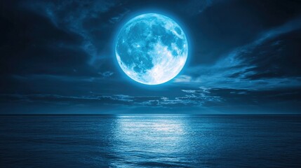 Wall Mural - A full blue moon casting a soft glow over a tranquil ocean at night.