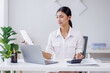 © David - Asian Business woman using calculator and laptop for doing math finance on an office desk, tax, report, accounting, statistics, and analytical research concept