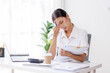 © David - Portrait of tired young business Asian woman work with documents tax laptop computer in office. Sad, unhappy, Worried, Depression, or employee life stress concept.