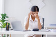 © David - Portrait of tired young business Asian woman work with documents tax laptop computer in office. Sad, unhappy, Worried, Depression, or employee life stress concept.