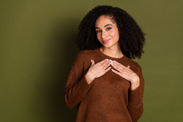 Poster - Photo of nice young woman arms touch chest wear pullover isolated on khaki color background